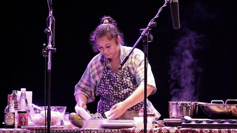 Musikerin steht vor gedecktem Tisch