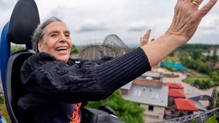 Ursel, 85, sitzt in der Achterbahn und reißt begeistert die Arme in die Luft