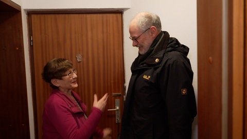 Ein Mitarbeiter vom Verein „Alt-Arm-Allein“ besucht eine ältere Frau, um ehrenamtlich Handwerksarbeiten durchzuführen.