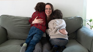 Mutte rmit zwei Kindern auf dem Sofa