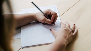 Patricia berät als Ergotherapeutin Linkshänder zur richtigen Schreibhaltung