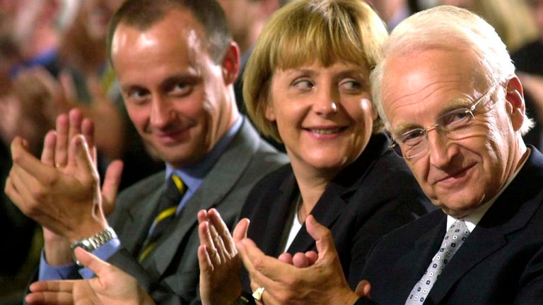 Angela Merkel, Friedrich Merz und Edmund Stoiber klatschen und lächeln