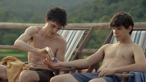 Gabriel (Fabio Audi) macht dem blinden Leo (Ghilherme Lobo) Sonnencreme auf seine Hand. Szene aus "Heute gehe ich allein nach Hause")