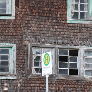 Verfallenes altes Bauernhaus mit verwitterten Holzschindeln.