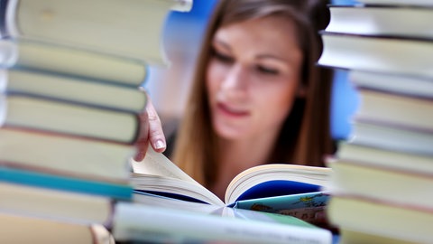 Frau mit Bücherstapel