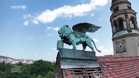Eine Löwenfigur auf einem Kirchendach