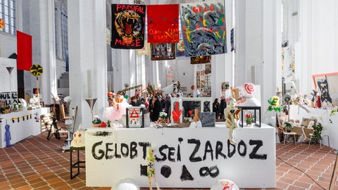 Die Installation "GrossmutterMacht" des Künstlers Jonathan Meese war 2019 in der Kirche St. Petri in Lübeck zu sehen. Sie war eine von zwei Ausstellungen des Projektes "Dr. Zuhause: K.U.N.S.T.(ERZLIEBE)".