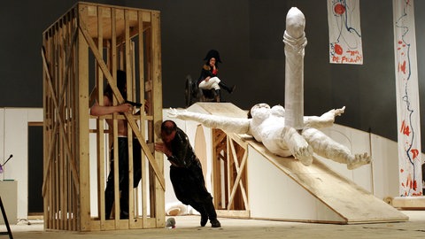 Jonathan Meese (im Käfig) und Berhard Schütz in einer Szene des Stücks "De Frau" von Jonathan Meese, das 2007 an der Volksbühne am Rosa-Luxemburg-Platz in Berlin Premiere hat. 