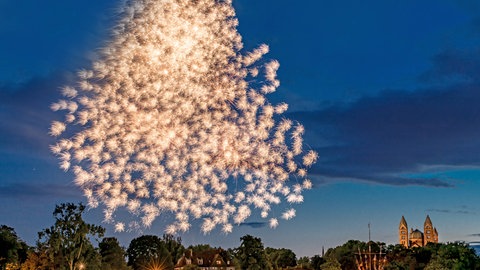Feuerwerk über dem Rhein mit einem Schiff und dem Dom in Speyer in Deutschland