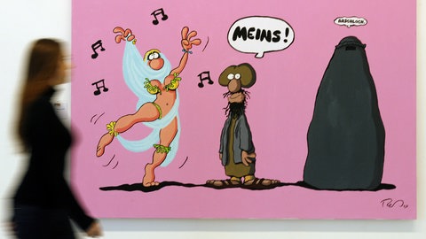 Karikatur von Ralf König zeigt einen Islamisten mit verhüllter Frau, der einer wenig verhüllten Schleiertänzerin hinterherschaut