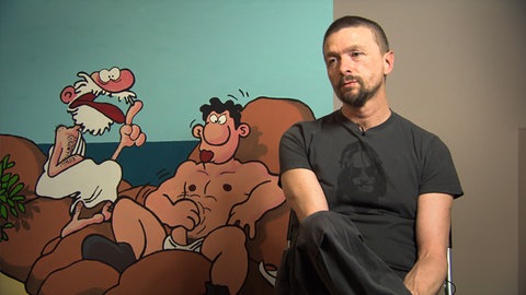 Ralf König in einer Szene des Films „König des Comics - Ralf König“. 