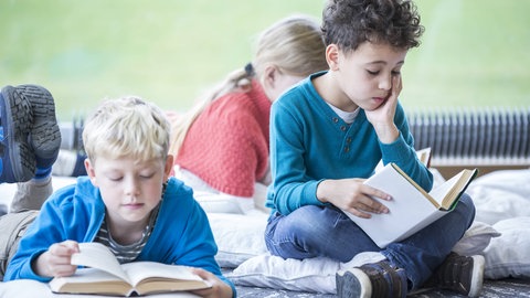 Zwei Kinder lesen Bücher