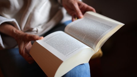 Eine Frau liest ein Buch.