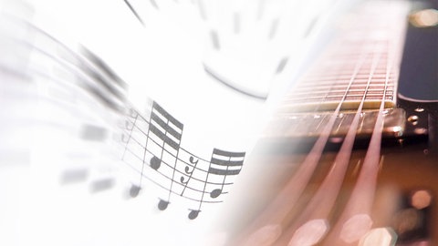 Ein Notenblatt und eine Gitarre als Symbol für Musik