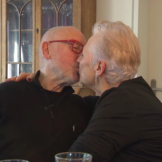 Ein älteres Paar küsst sich