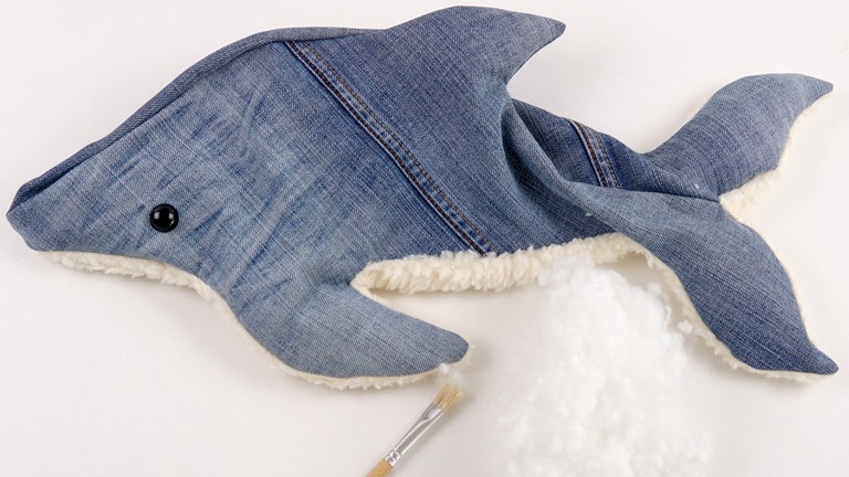 Zunächst die Seitenflossen, die Rückenflosse und den Schwanz ca. 3 cm dick mit Füllwatte ausstopfen. 