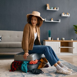 Frau versucht Koffer zu packen