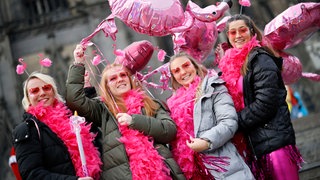 Junge Frauen sind zum Karneval als Flamingos verkleidet.