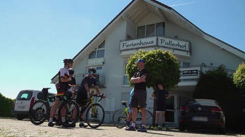 Triathleten stehen vor dem Ferienhaus Fallerhof