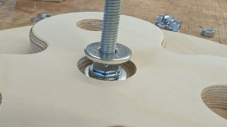 Gewindestab durch Grundplatte führen, Mutter + Unterlagscheibe unten befestigen, Platten aufstecken und mit Unterlagscheiben + Muttern so befestigen, dass jede Platte drehbar bleibt. Leckerli einfüllen. 