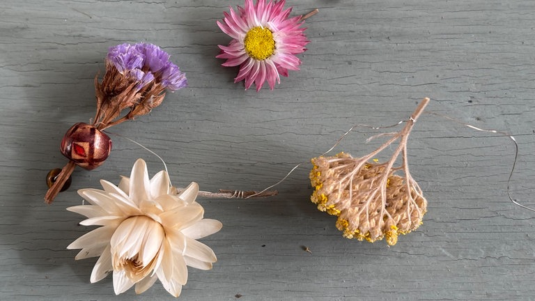 Die ersten Blumen, durch einfaches umwickeln der Stiele, am Draht befestigen. 