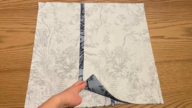 Danach werden beide Rückteile rechts auf rechts auf das Vorderteil gelegt und rundherum festgesteckt. 