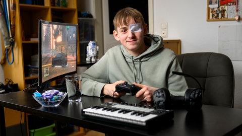 Peter mit einem Controller und Videospiel auf dem Computer, tags: Behandlung krebs Kinder krebskrank medikament