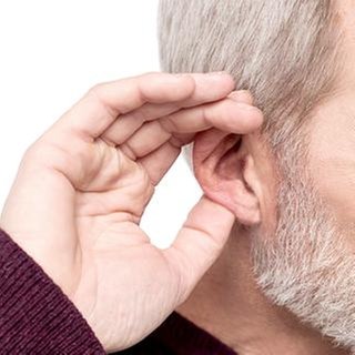Mann hält sich die Hand ans Ohr