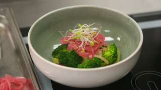 Brokkoli-Röschen mit rosaroten Rettich-Streifen und Sprossen in Schälchen. Rezept für sommerlichen, gesunden, leichten Brokkoli-Salat.