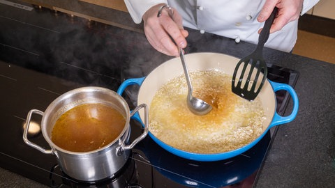 Bärlauch-Risotto kochen: Das Risotto wird mit Weißwein abgelöscht.
