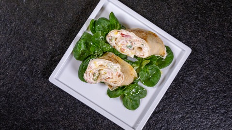 Angerichtete Pfannkuchen mit einer Füllung aus Lachs und Frischkäse