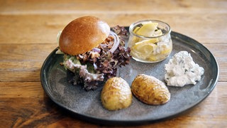 Ziegenburger mit Hasselback-Kartoffeln auf einem Teller