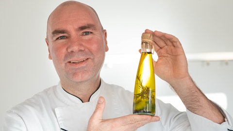Eberhard Braun präsentiert das fertige Limetten-Rosmarin-Öl