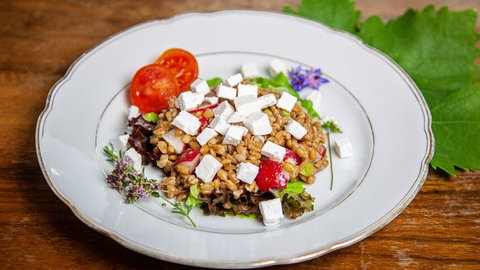 Dinkelsalat mit Ziegenkäse auf einem Teller