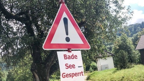 Warnschild mit der Aufschrift "Badesee gesperrt": Umgekippte Badeseen sind nicht nur für die Umwelt eine Katastrophe, sie bergen auch für uns Menschen gesundheitliche Risiken. 