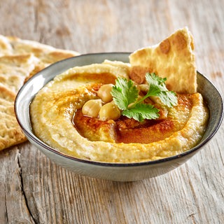 Hummus in einem Schüsselchen mit Fladenbrot. Marktcheck testet Hummus von Edeka, Netto und Lidl.