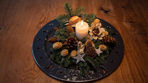 Eine Schale mit Weihnachtsdekoration steht auf einem Tisch.