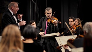 Nicholas McGegan (l.), Gil Shaham und das SWR Symphonieorchester