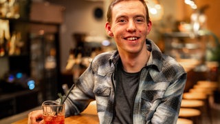 Ein junger Mann in einer Bar