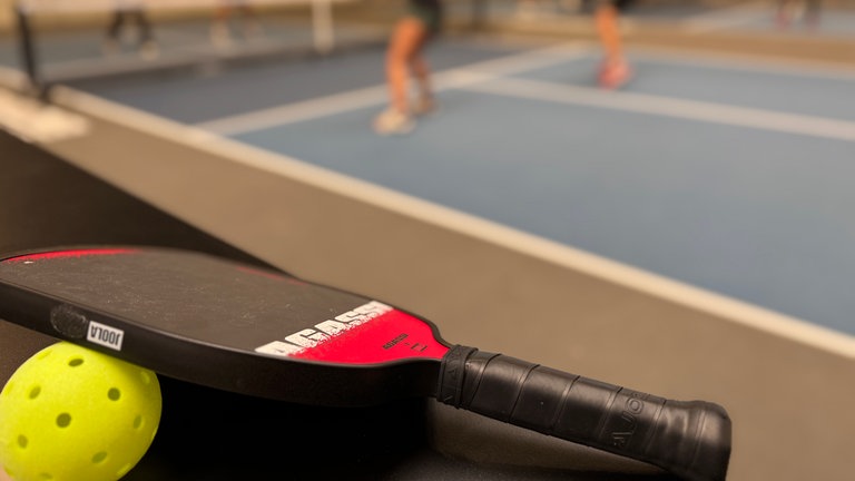 Pickleball Schläger und Ball.