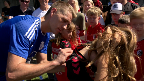 Nils Petersen gibt nach seinem ersten Spiel für Oberried ein Autogramm auf dem Trikot eines weiblichen Fans.
