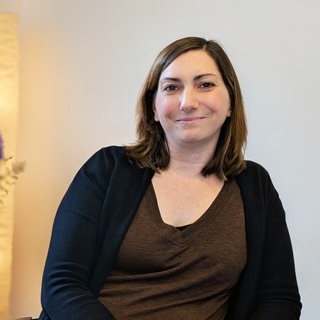 Britta Bosch sitzend, neben ihr ein Blumenstrauß