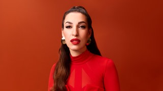 Tijen Onaran, Unternehmerin, blickt in rotem Outfit in die Kamera. In SWR1 Leute spricht sie über bessere Kommunikation im Internet, privat und beruflich.