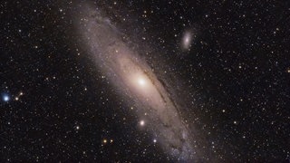 Symbolbild für Universum, Galaxien und Sterne. Die Andromeda-Galaxie ist sichtbar im schwarzen All.