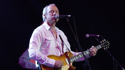 Mark Knopfler und die Dire Straits hatten mit "Money For Nothing" einen großen Hit