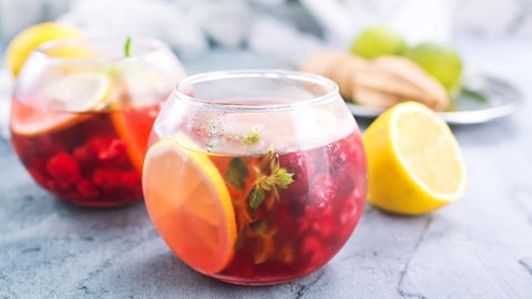Rezepte Cocktail alkoholfrei: Mehrere Gläser mit Cocktails stehen nebeneinander, daneben liegt eine angeschnittene Zitrone.