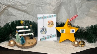 Drei Bastelideen für Geldgeschenke an Weihnachten: ein gelber Filzstern, Geldscheine als Äste eines Baumes auf einer Holzscheibe und eine Weihnachtskarte mit Geld-Christbaumkugeln.