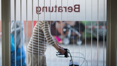 Das Wort "Beratung" steht von außen lesbar an einem Fenster des Caritas-Zentrum