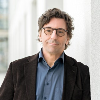 Gerhard Leitner steht im Gang eines SWR-Gebäudes