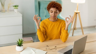 No stress keep calm. Mindful African businesswoman practices breathing exercises at home office.